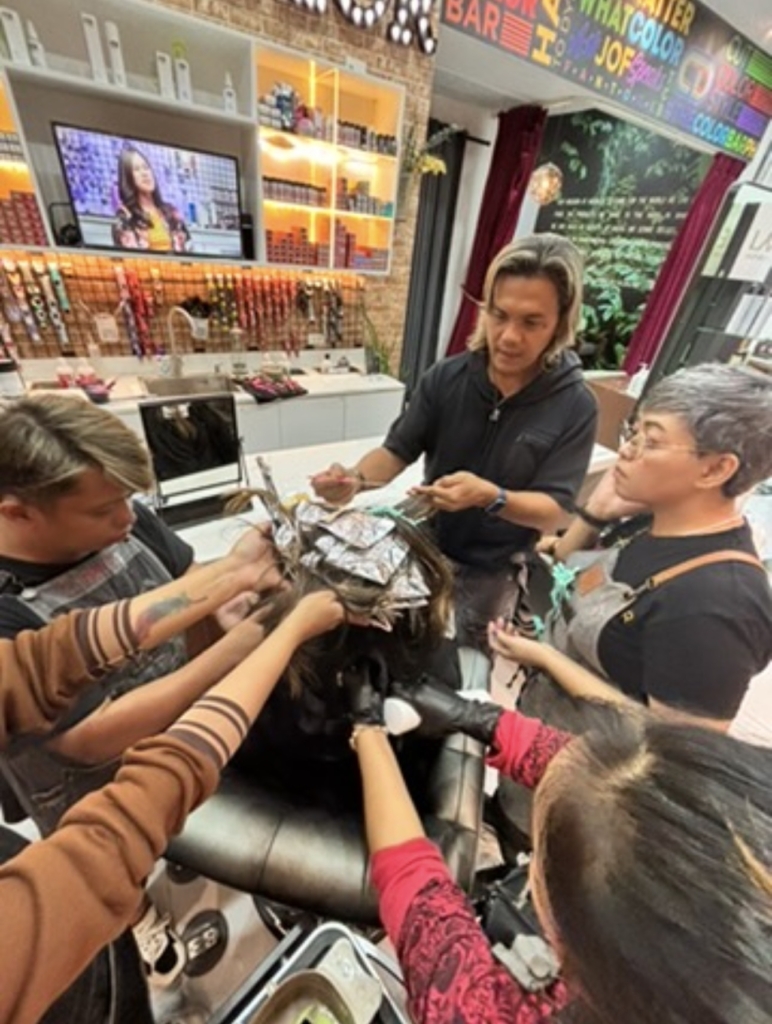 Color Baristas performing professional hair color consultation and application.